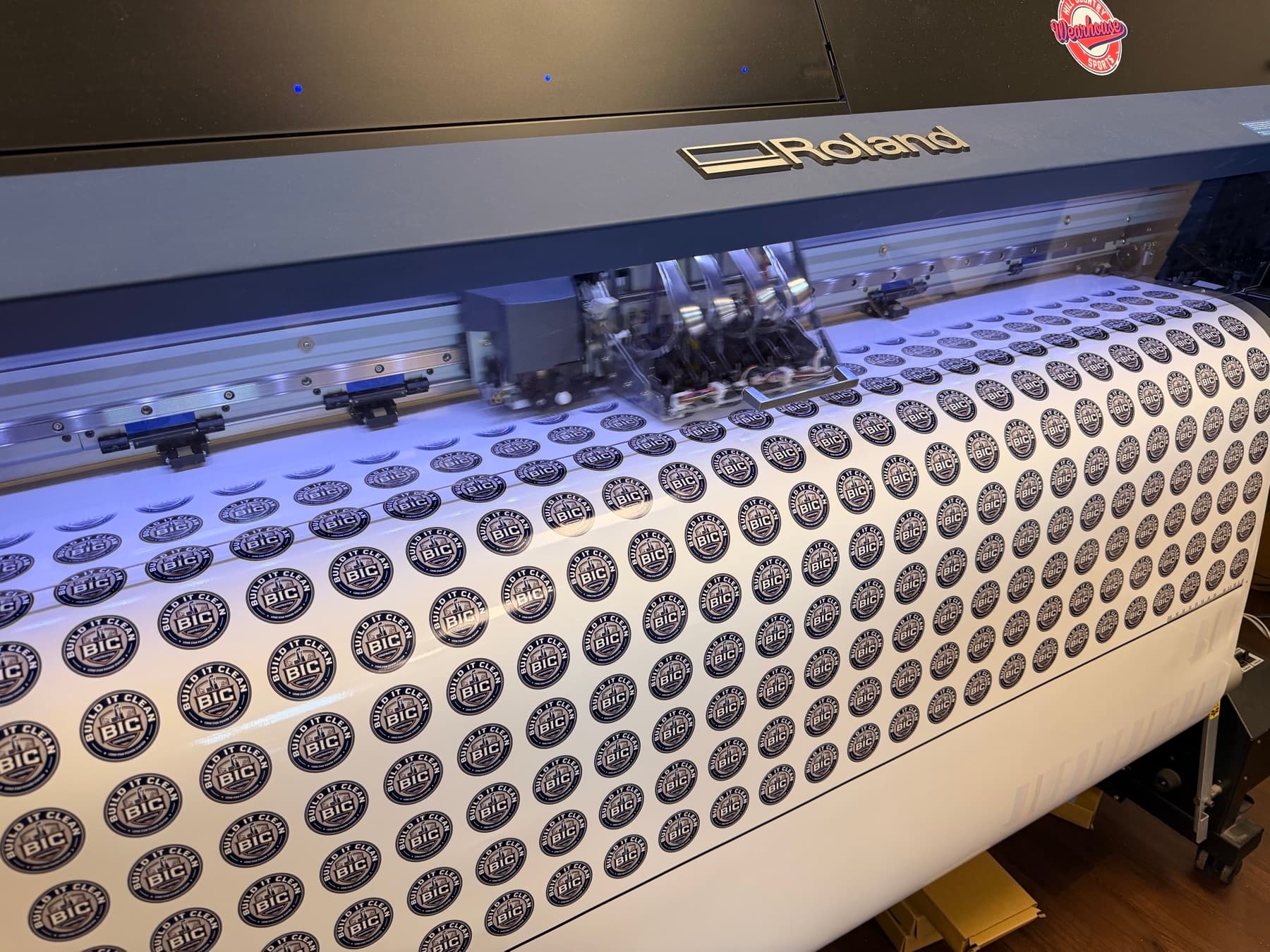 Hundreds of circular logo stickers printing on the wide-format printer