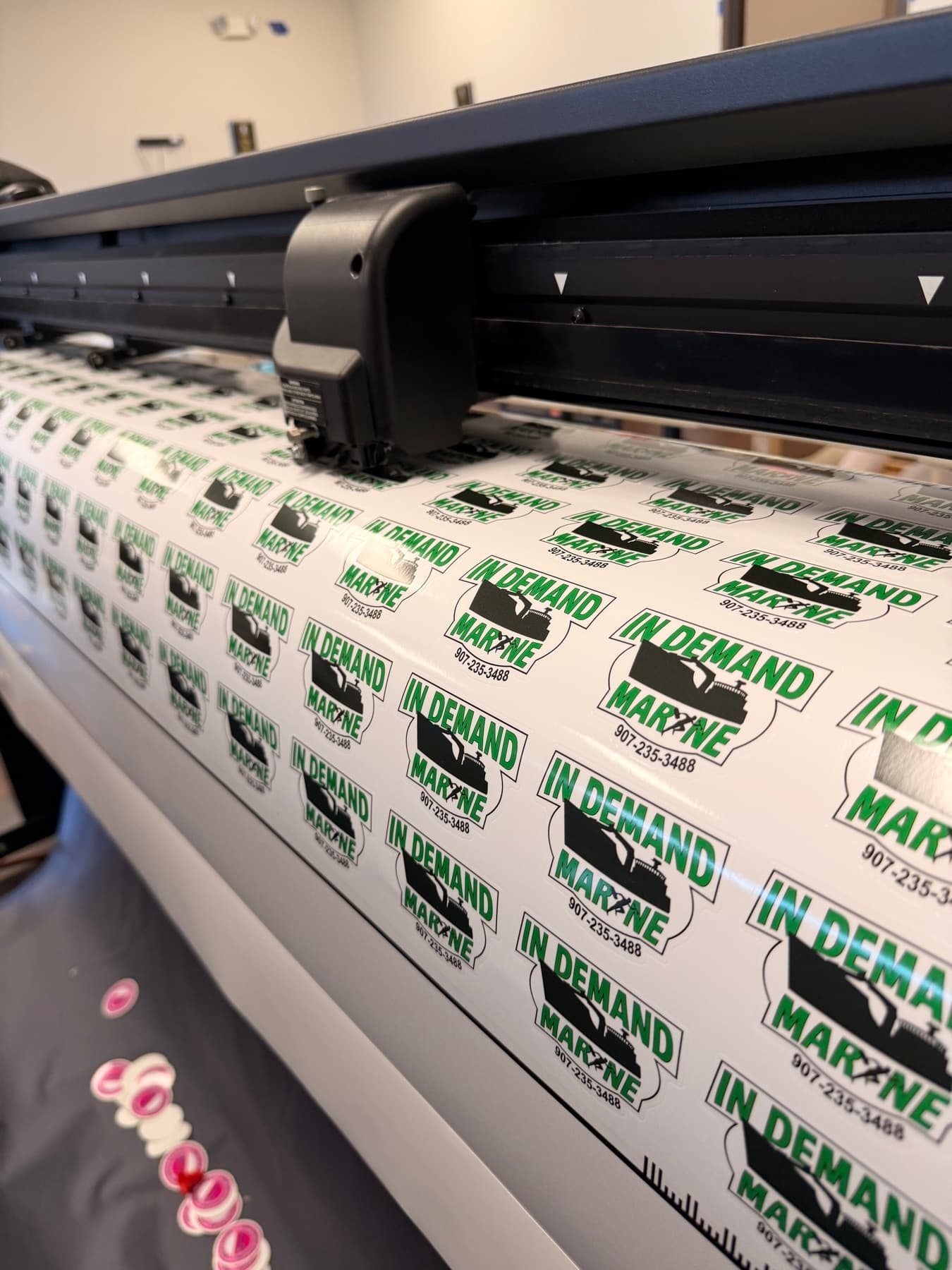 Contour-cut marine logo stickers on the cutter