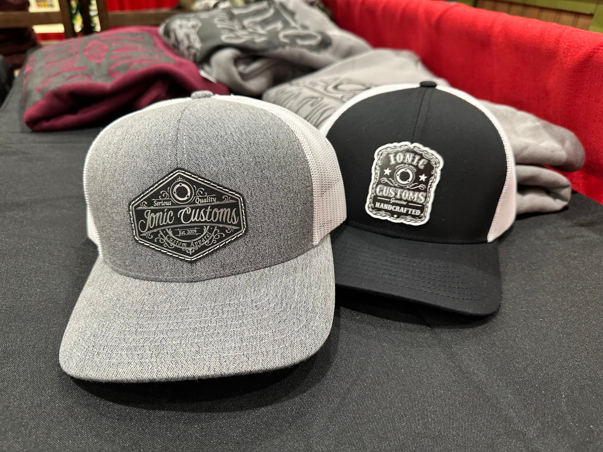 Two engraved leather patch hats from Ionic Customs